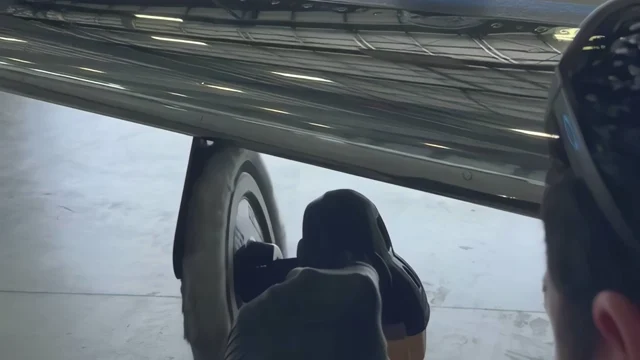 Gloved detailer polishing an aircraft leading edge