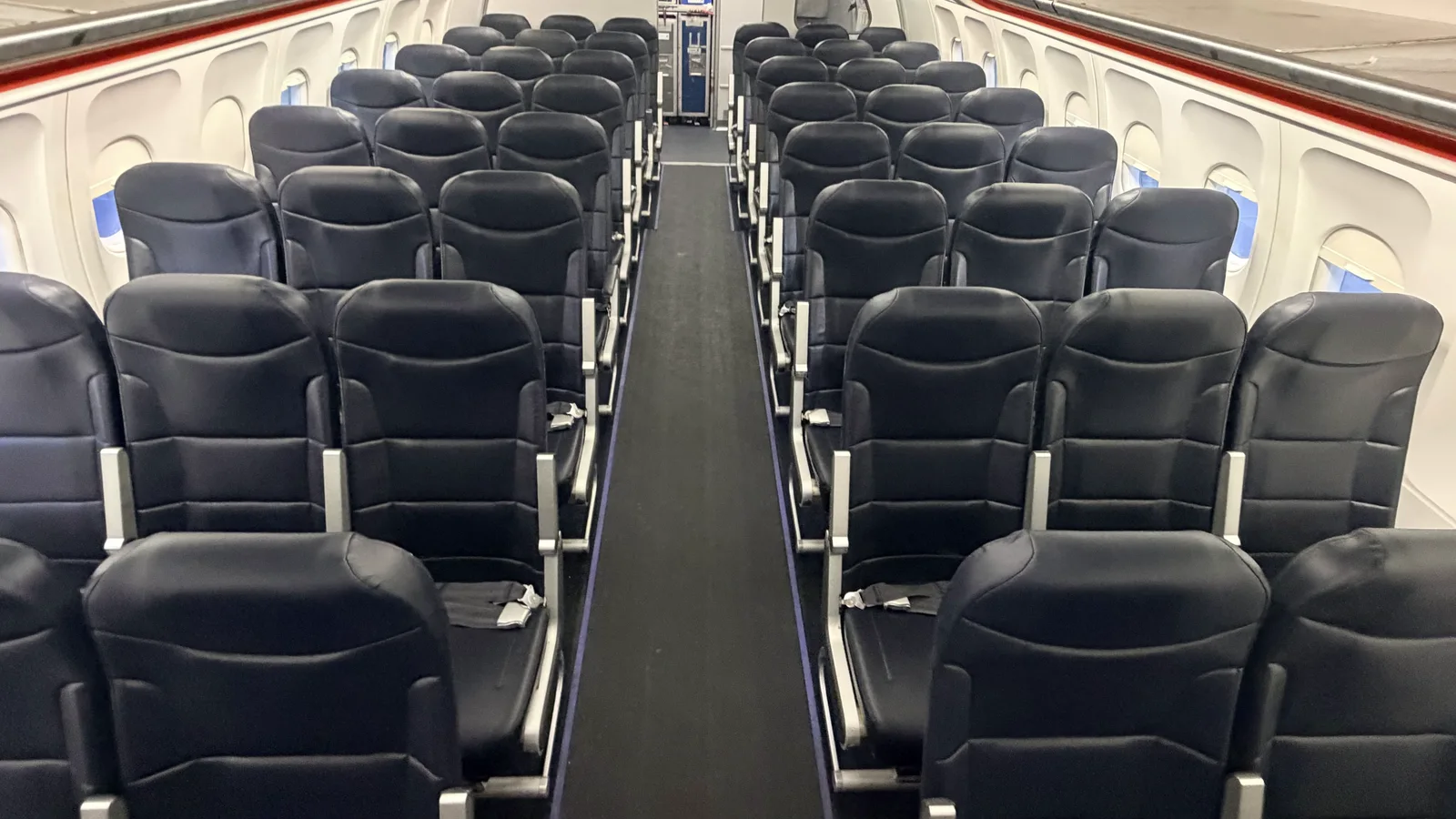 Passenger seats and aisle in a commercial aircraft cabin