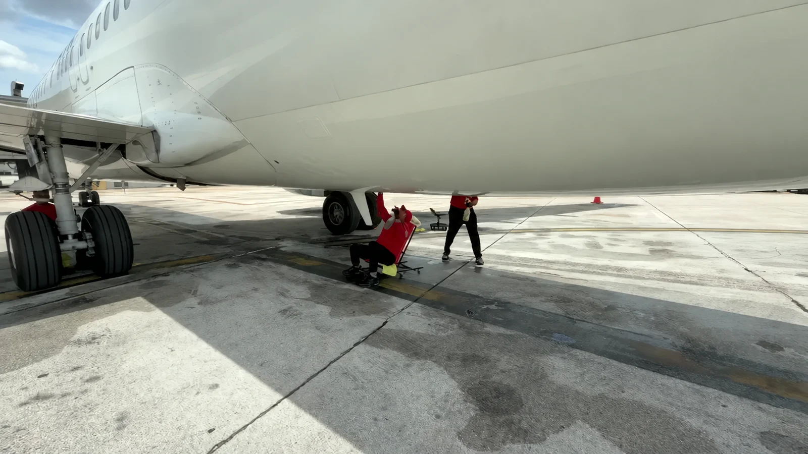 Cleaning crew washing a commercial aircraft exterior