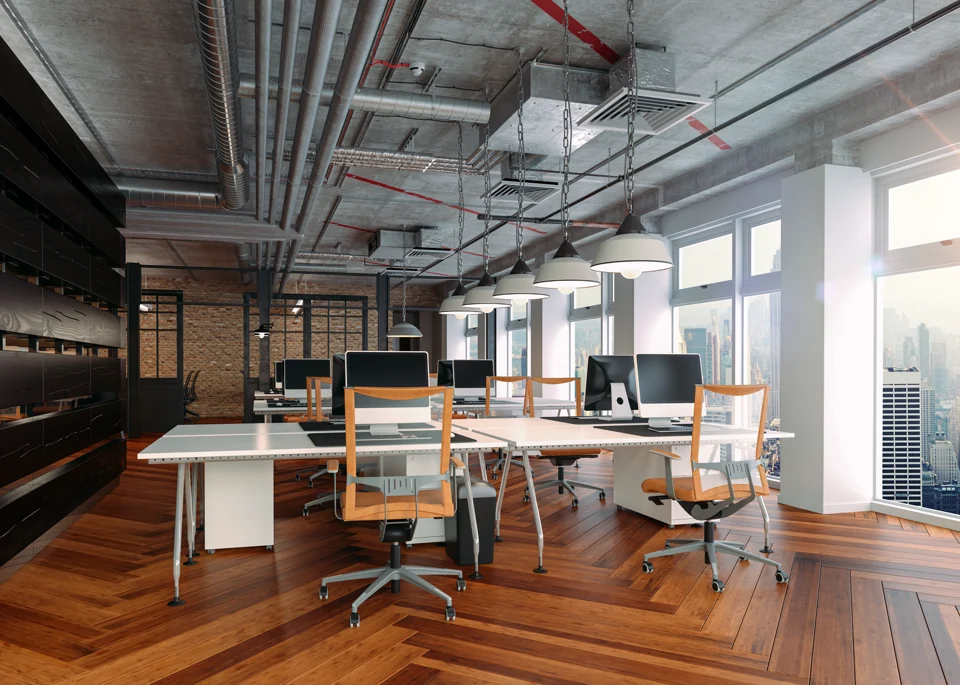 Illustrative office interior with desks, wood flooring, and shared workspaces